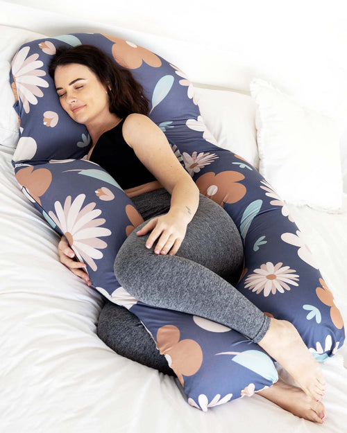 pregnant woman lying on pregnancy pillow