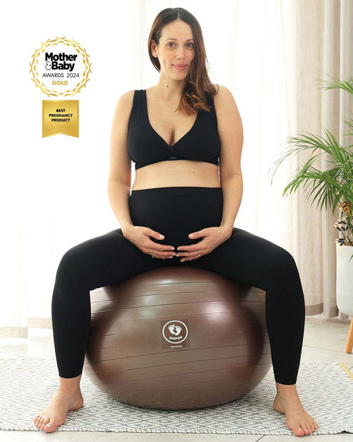 pregnant woman sat on brown birthing ball