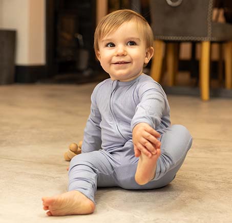 Happy baby wearing BABYGO® Slate Blue Ribbed Sleepsuit