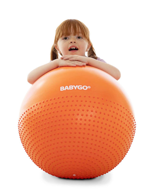 child on orange peanut ball