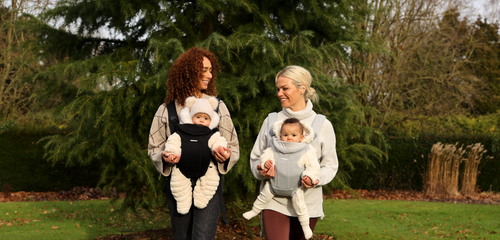 two mums with baby carriers