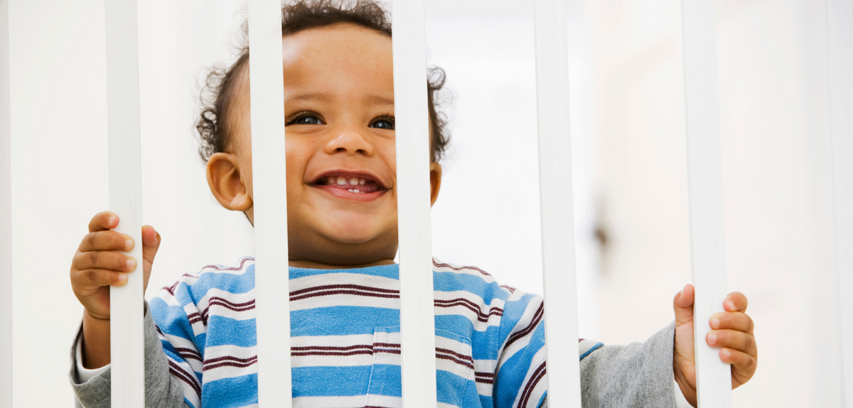 baby looking through gate