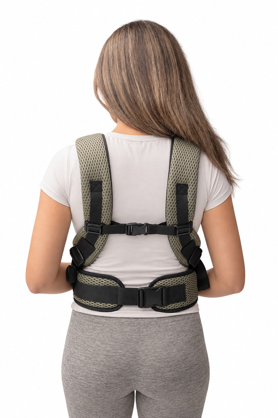 Rear view of a parent wearing the olive AirMesh carrier: padded shoulder straps, chest strap and waist belt