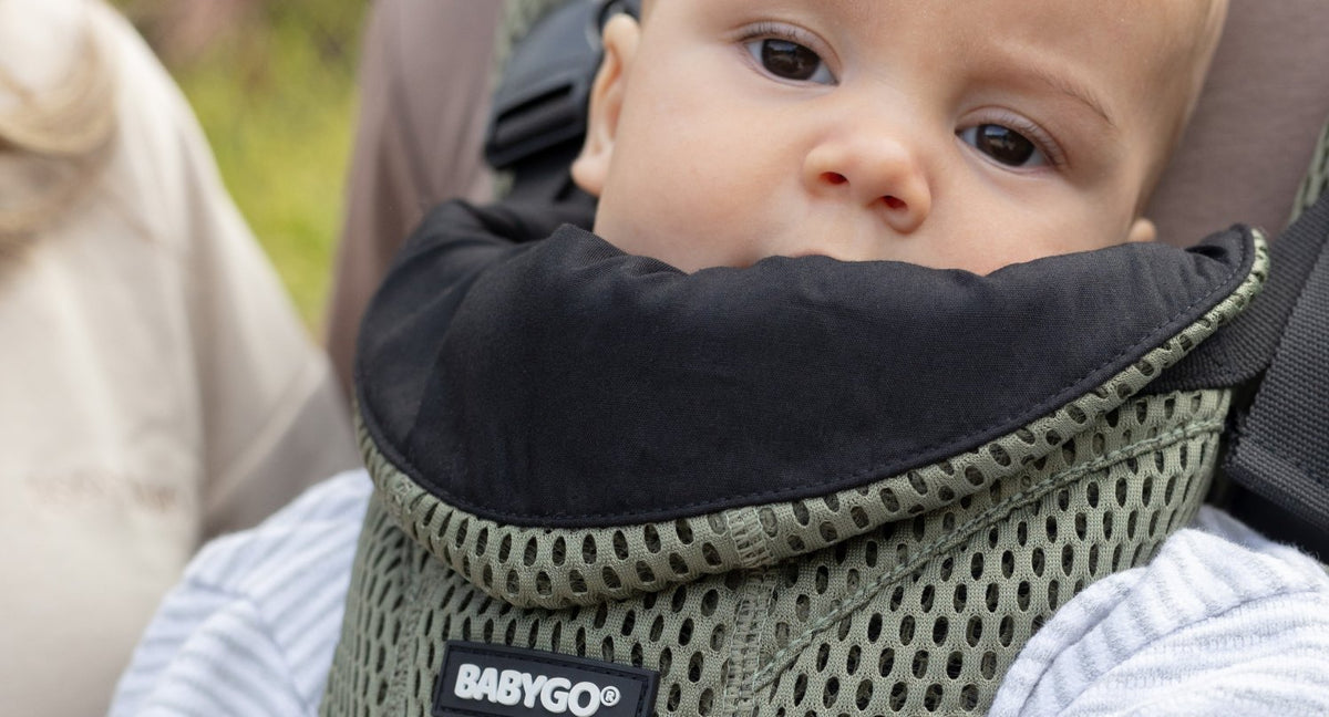 Baby wearing the AirMesh carrier with the organic cotton dribble bib