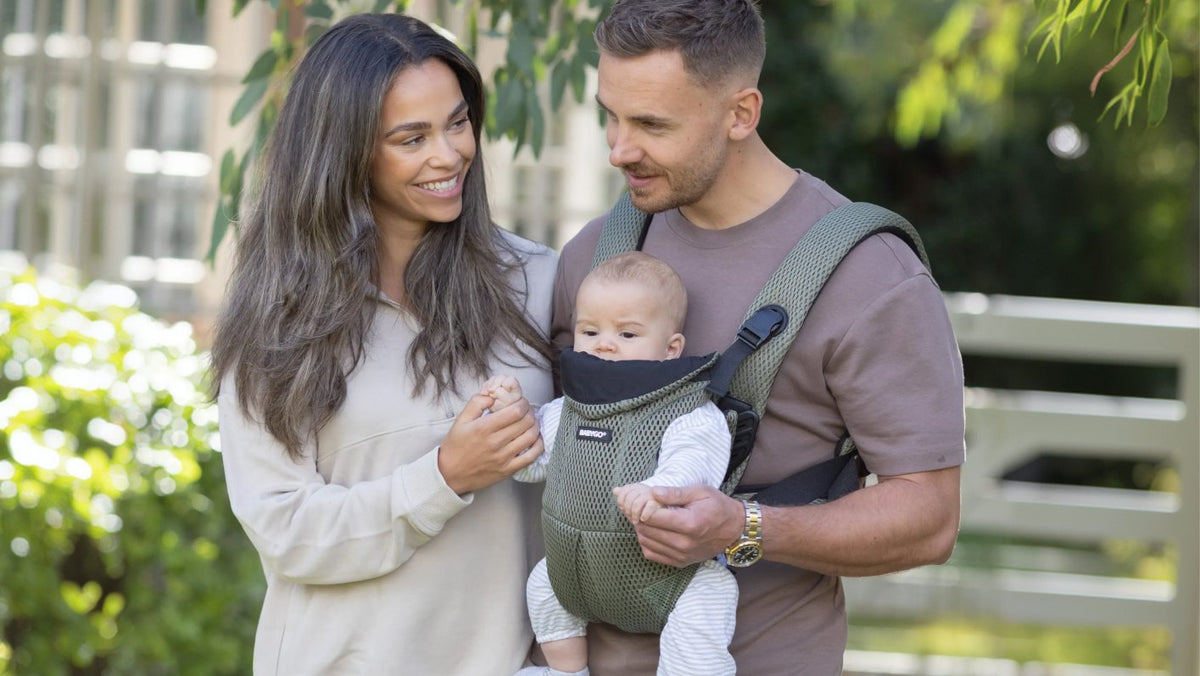 Parents with their baby facing out in the olive AirMesh carrier