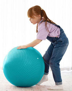 child with sensory exercise ball