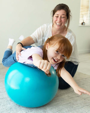 child on sensory exercise ball