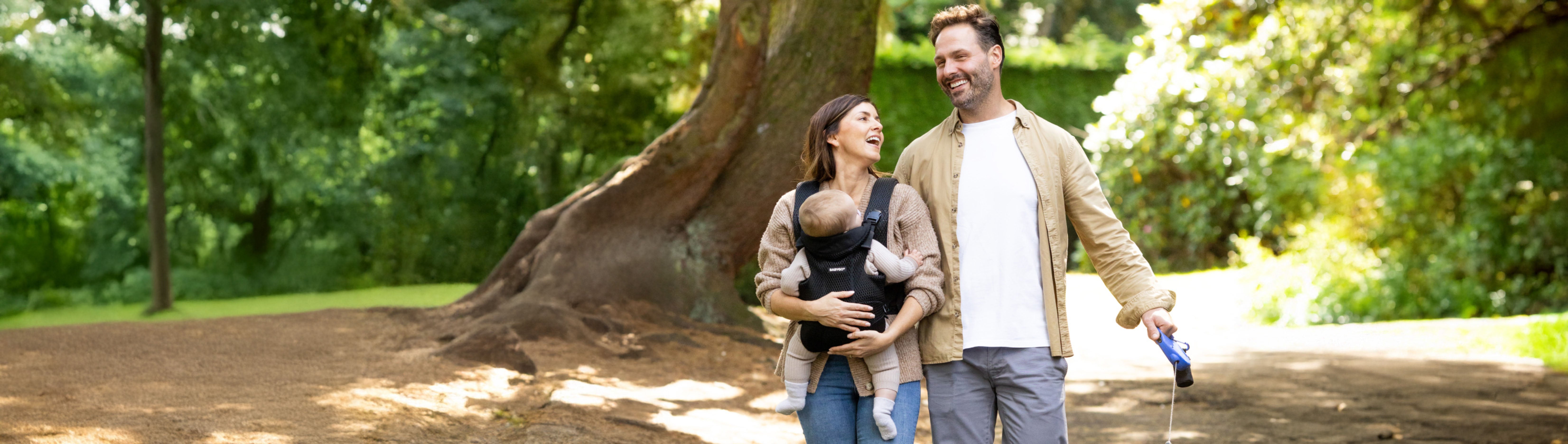 Image of a couple, with the BABYGO® Baby Carrier in use