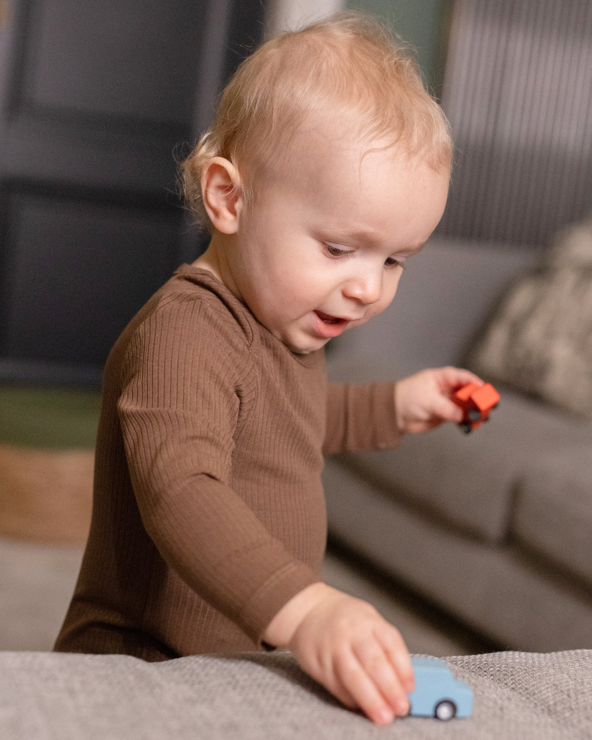 Baby playing in a mocha long sleeve bodysuit
