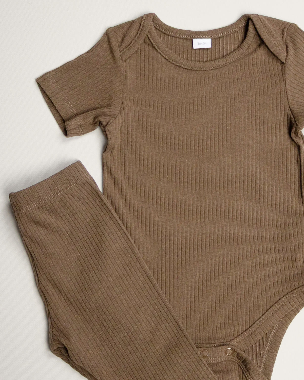 Baby wearing a mocha ribbed short sleeve bodysuit and leggings set, view 7
