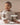 Baby wearing long sleeve bodysuit and leggings sets, twin pack in mocha and oatmeal, view 4