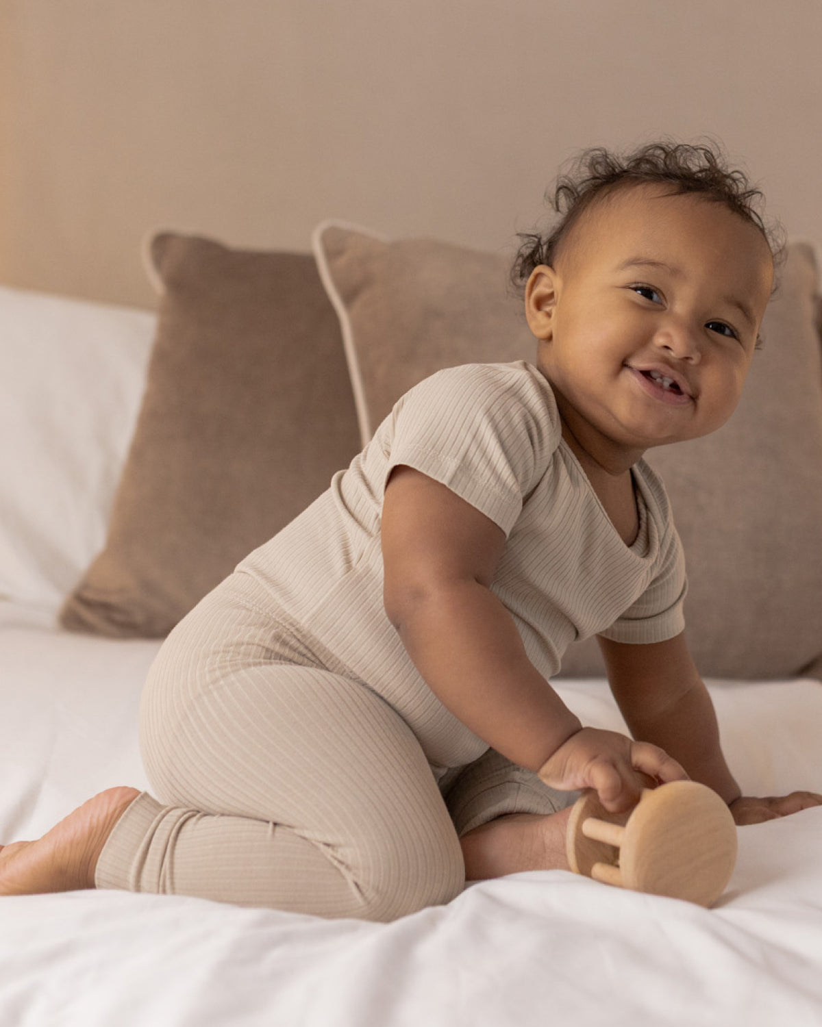 Baby wearing short sleeve bodysuit and leggings sets, twin pack in mocha and oatmeal, view 2