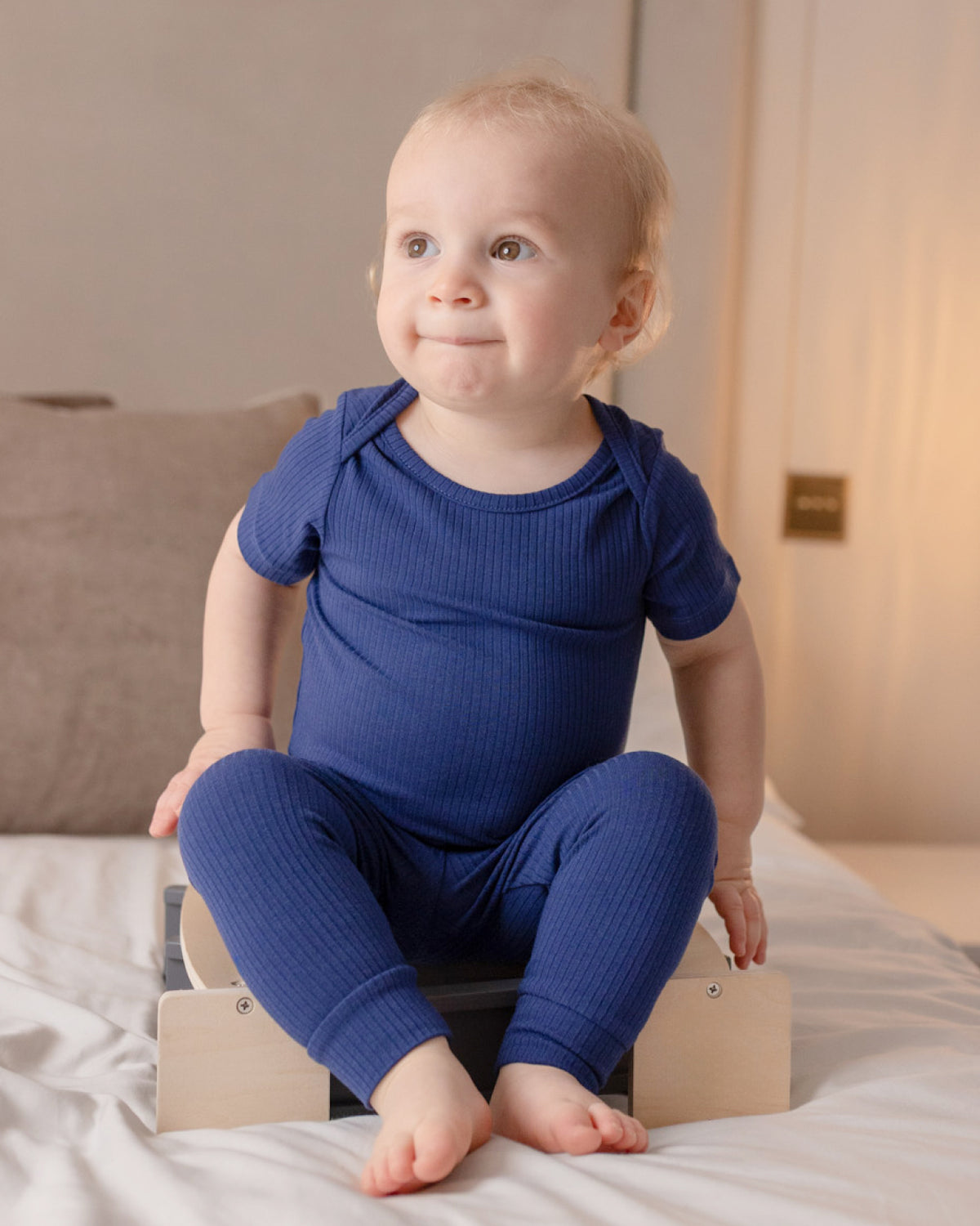 Baby wearing a navy ribbed short sleeve bodysuit and leggings set, view 2