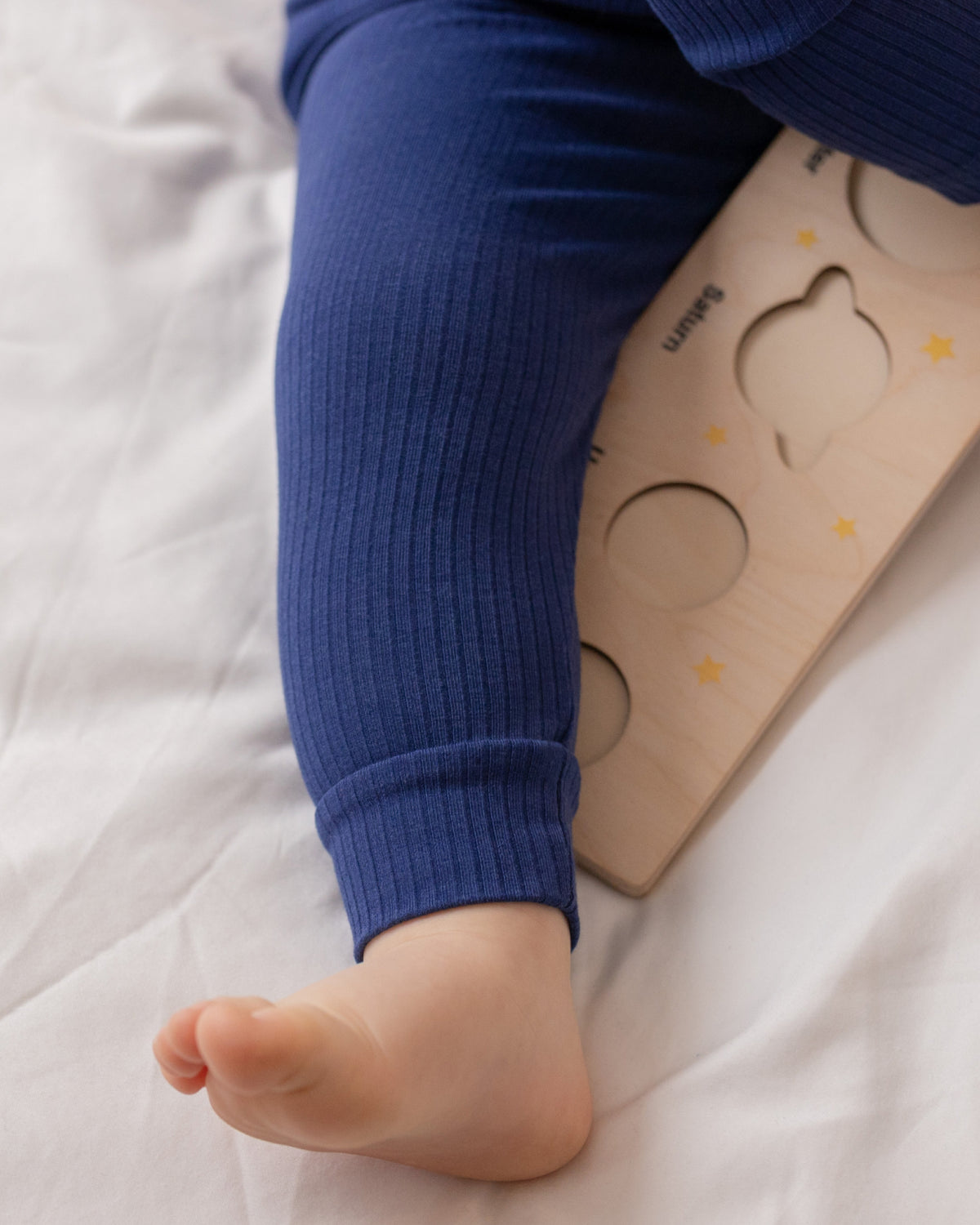 Baby wearing a navy ribbed long sleeve bodysuit and leggings set, view 5