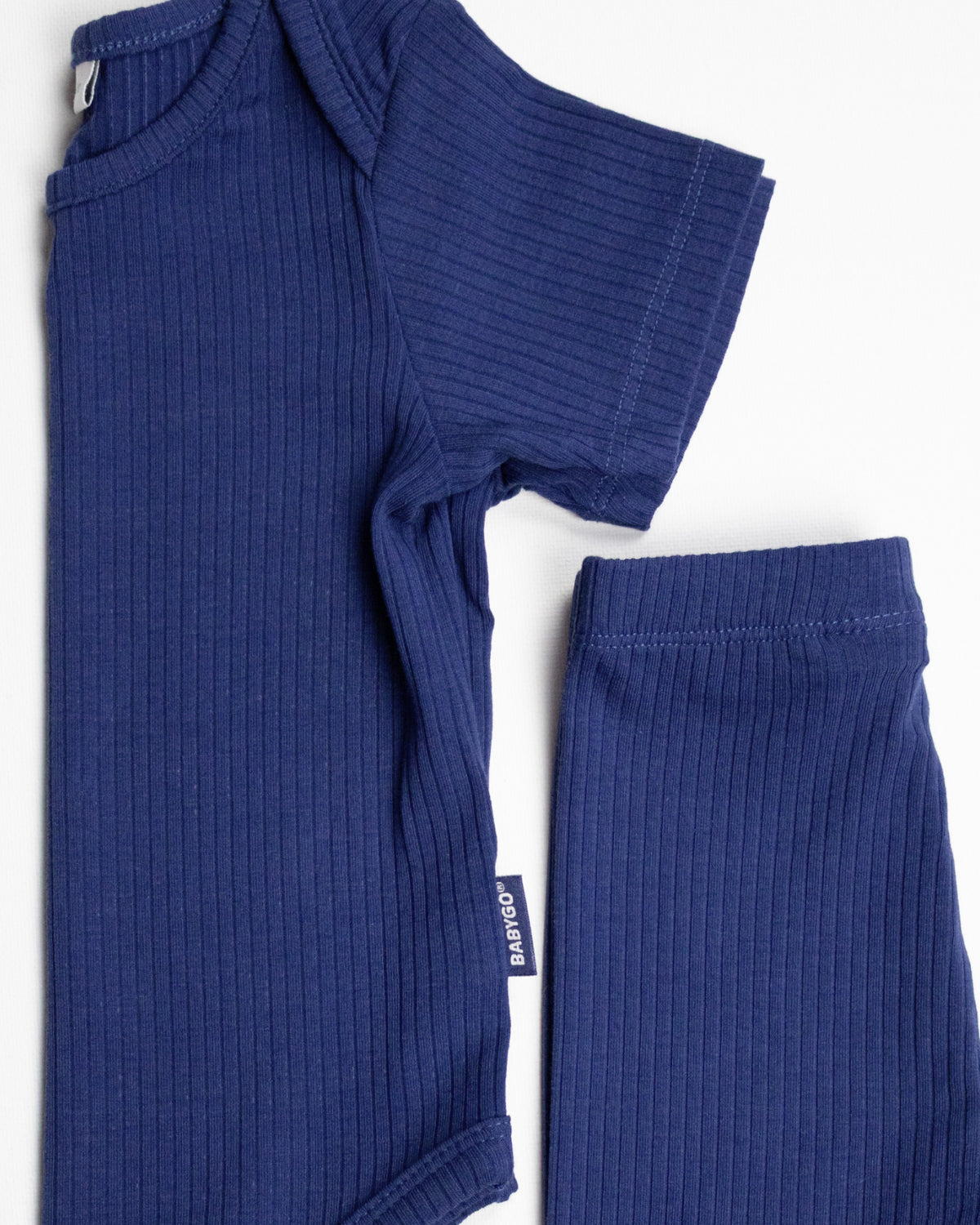 Baby wearing a navy ribbed short sleeve bodysuit and leggings set, view 7