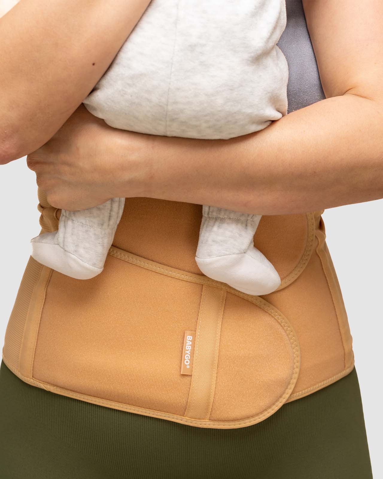 nude front facing postpartum recovery belt holding baby