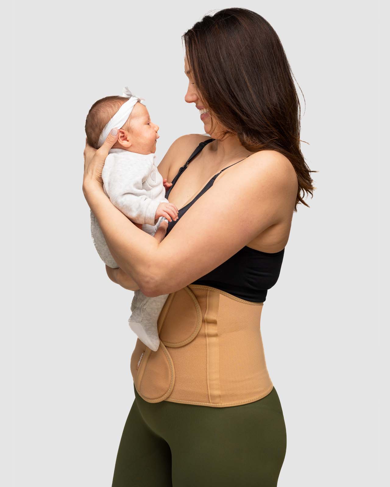 nude side on postpartum recovery belt with baby