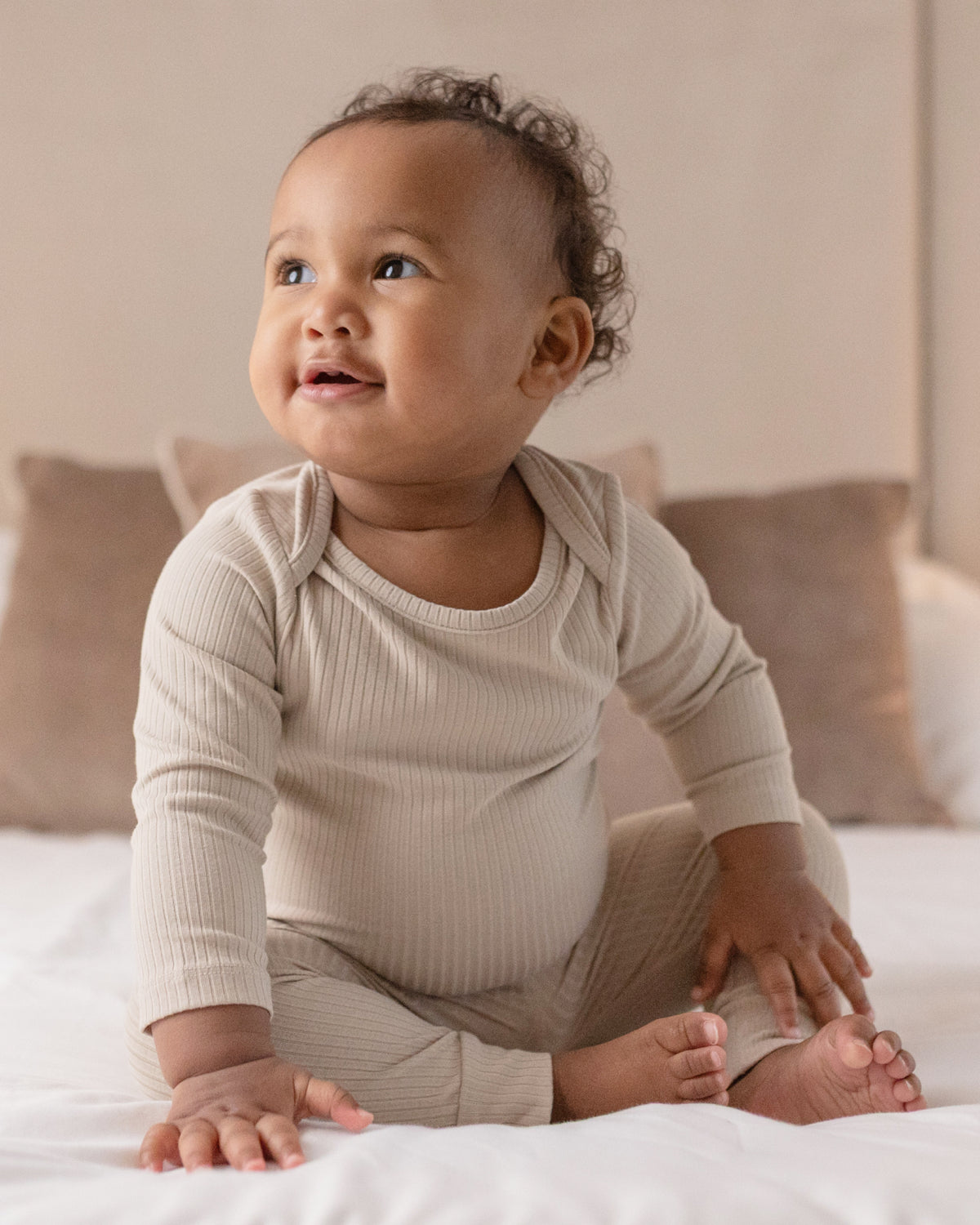 Baby wearing a oatmeal ribbed long sleeve bodysuit and leggings set, view 2
