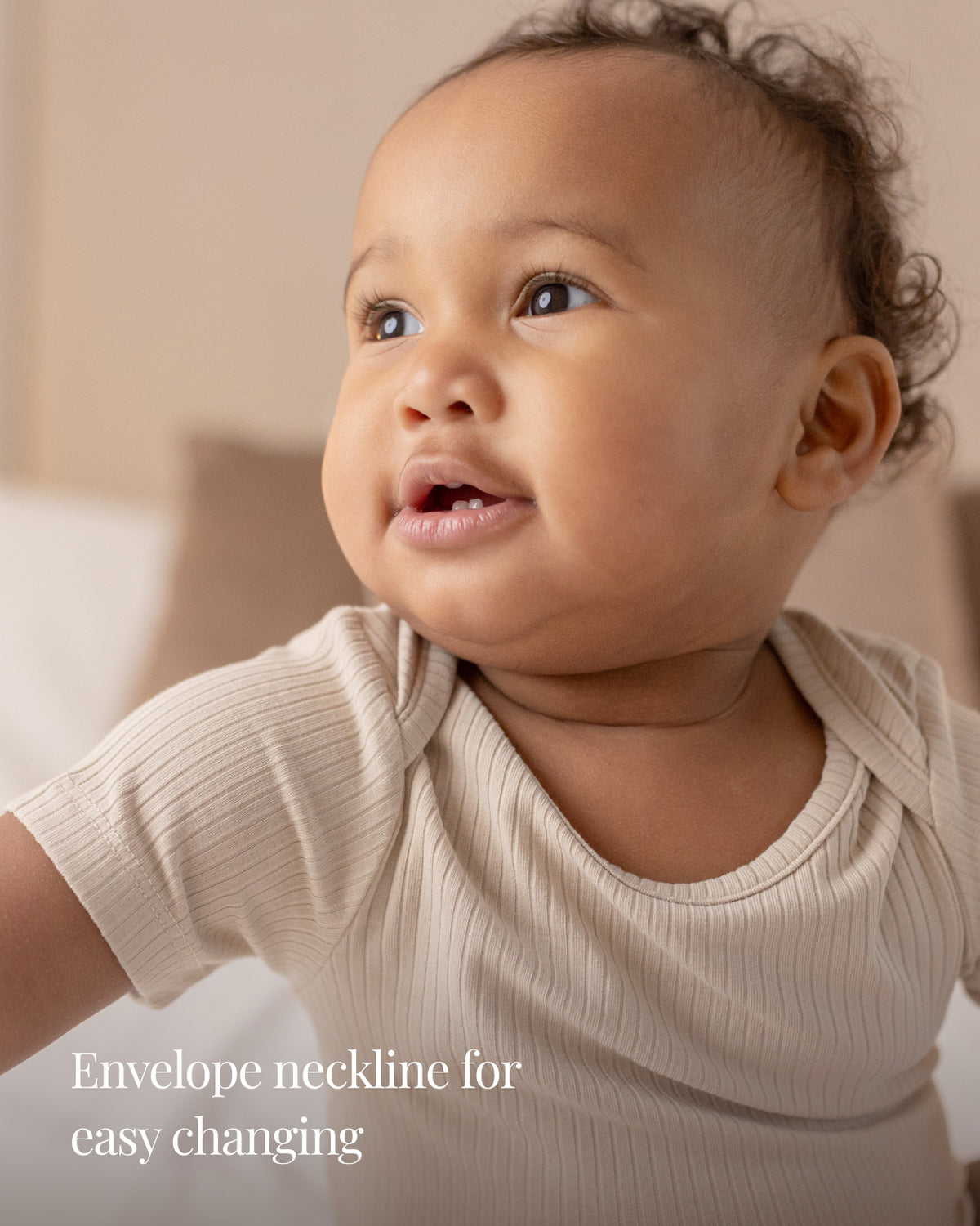 Oatmeal short sleeve bodysuit with an envelope neckline for easy changing