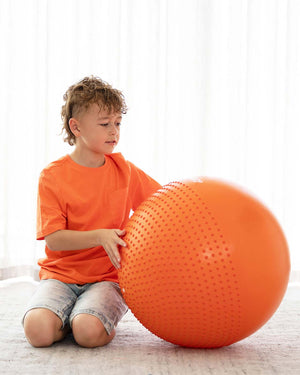 child playing with sensory ball
