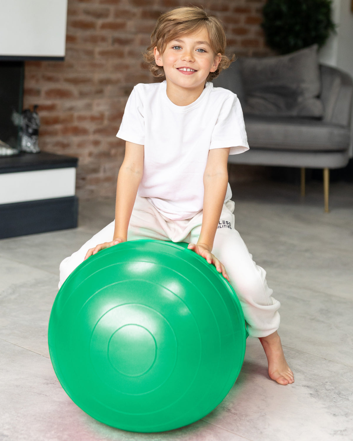 child sat on sensory peanut ball