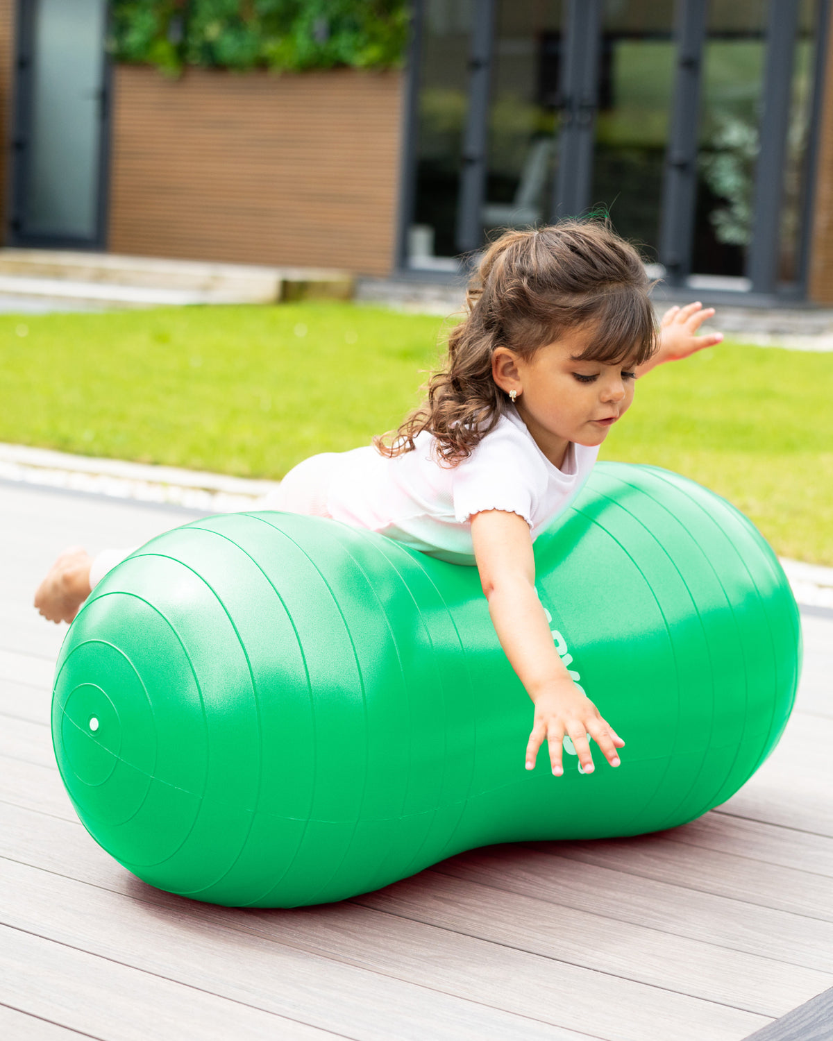 child playing on sensory peanut ball