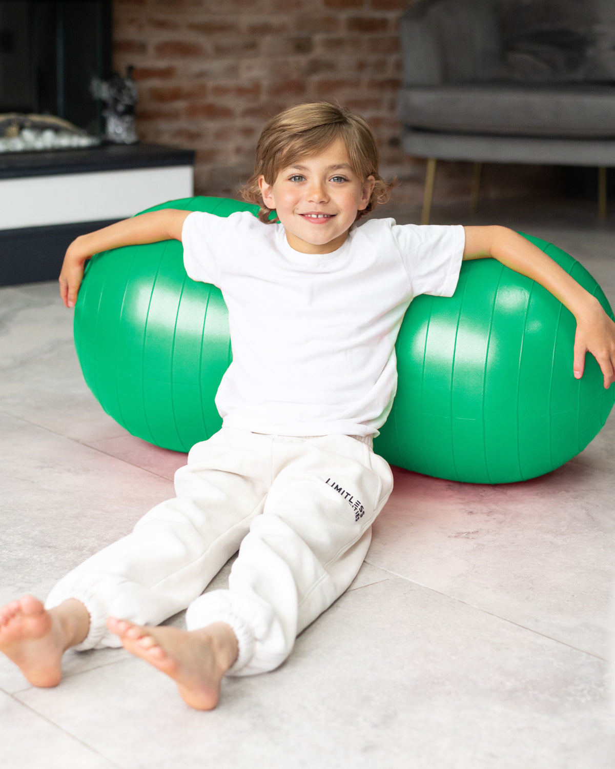 child sat with sensory peanut ball