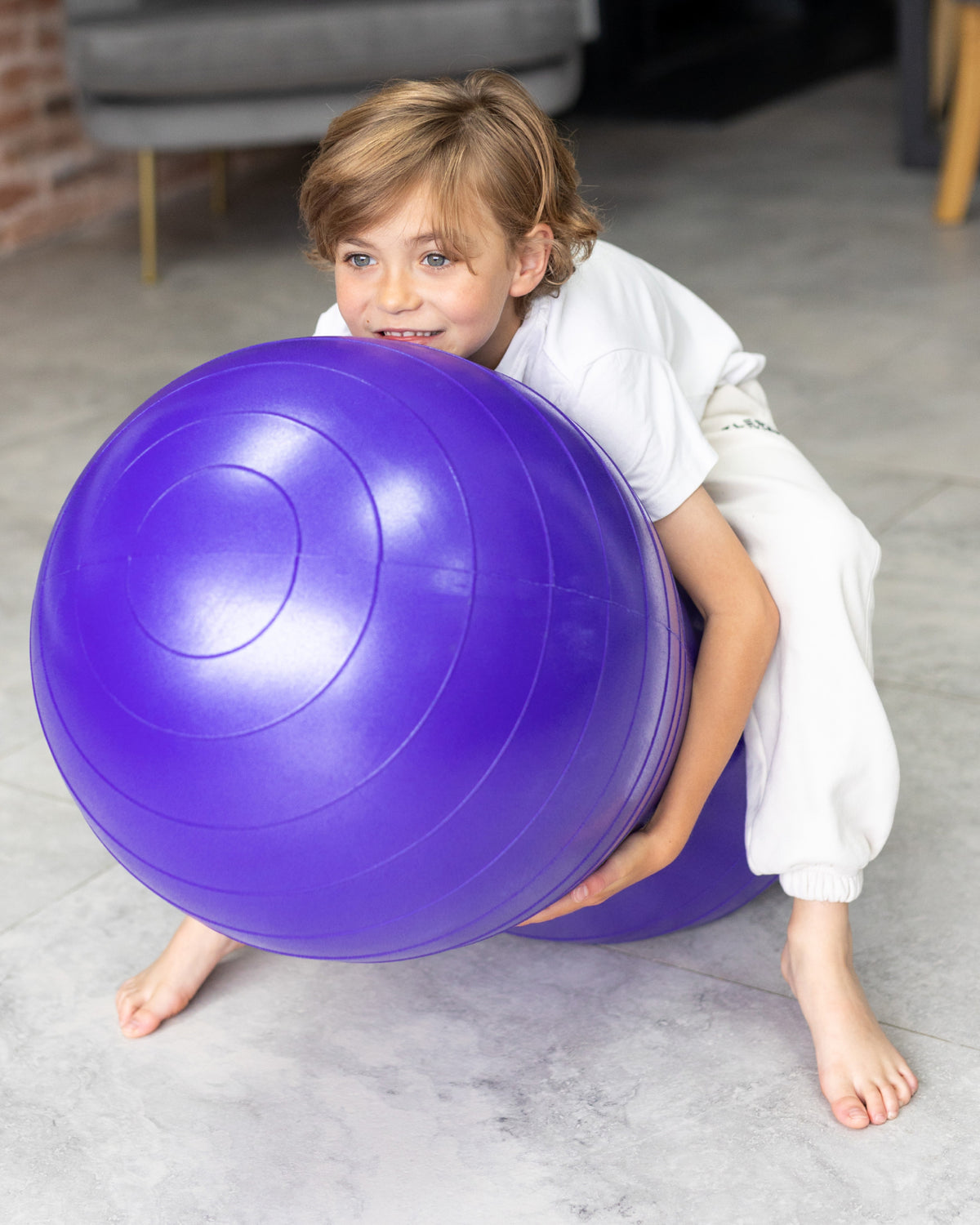 child on peanut sensory ball