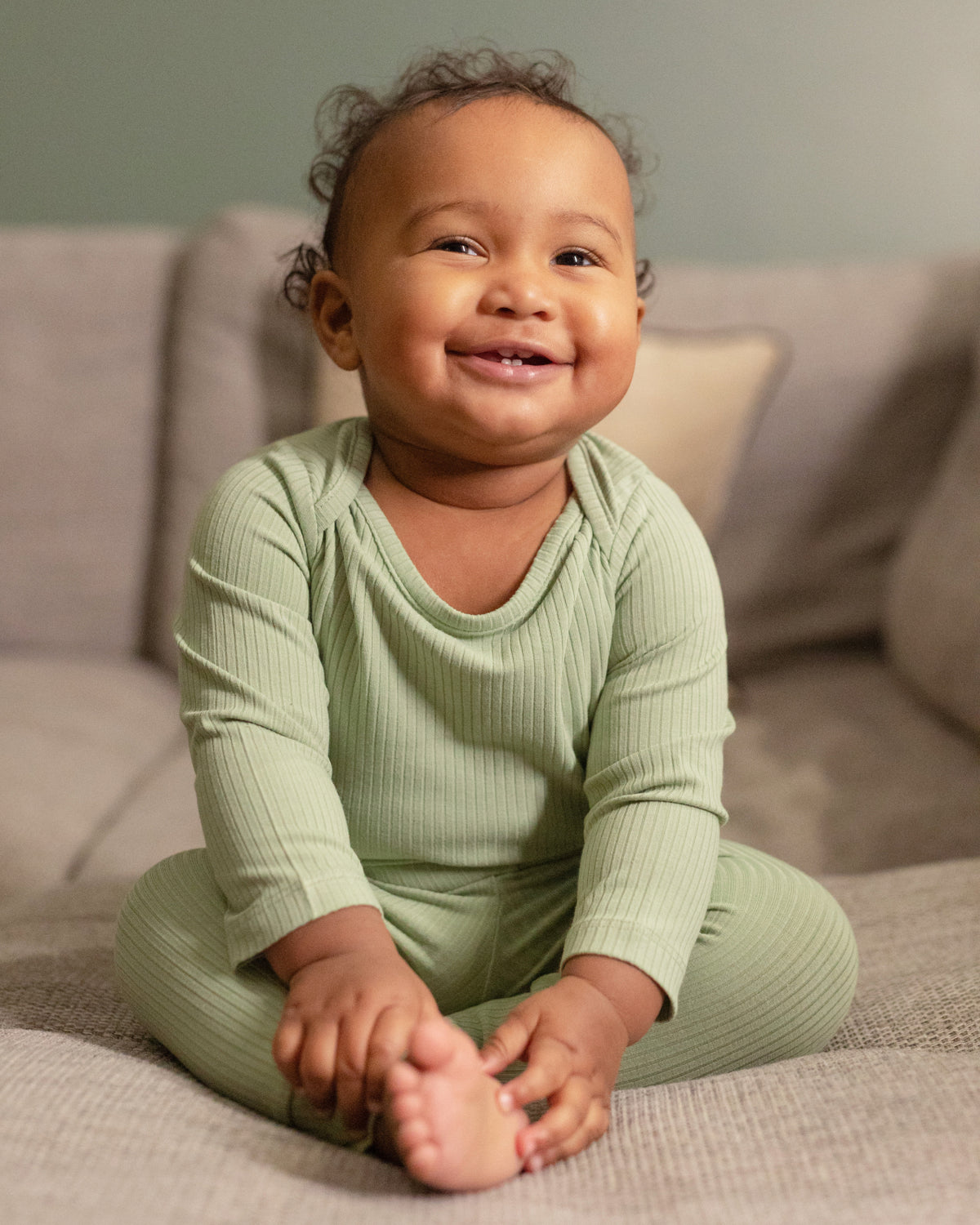Baby wearing a sage ribbed long sleeve bodysuit and leggings set, view 2