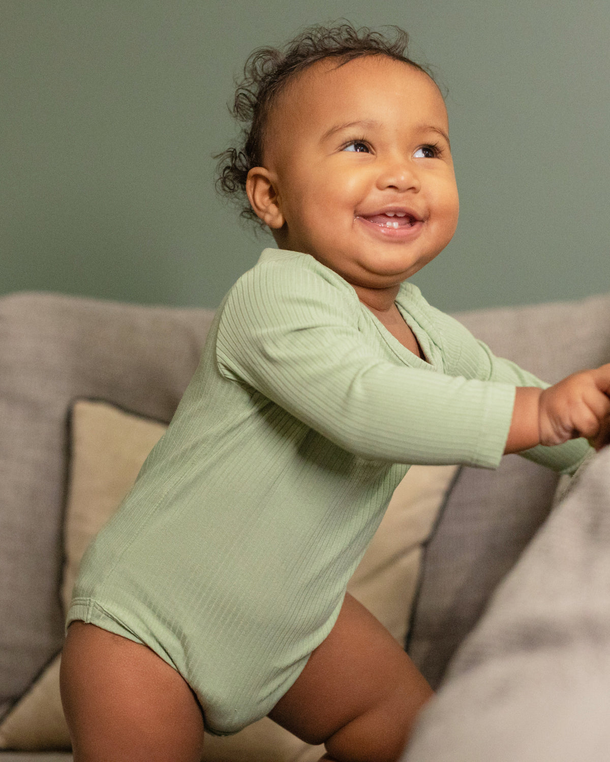 Baby wearing a sage ribbed long sleeve bodysuit and leggings set, view 6