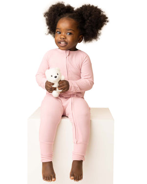 baby wearing pink baby grow