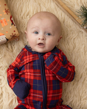 baby wearing tartan baby grow