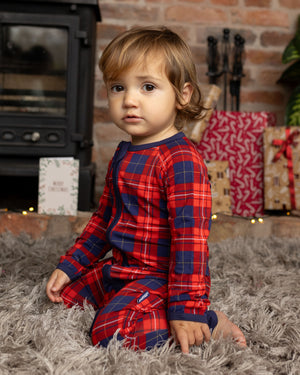 baby wearing tartan baby grow