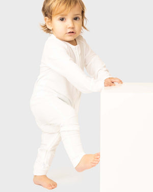 baby wearing white baby grow