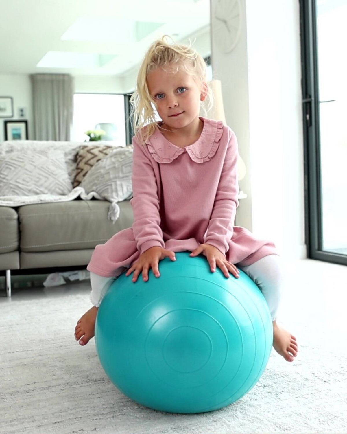 child sat on blue peanut ball