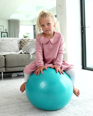 child sat on blue peanut ball