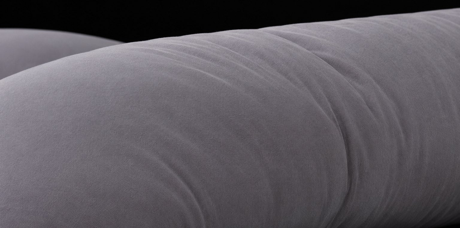 Close-up of the grey pillow cover and its soft folds.